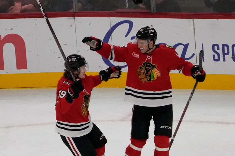 Oct 28, 2025; Chicago, Illinois, USA; Chicago Blackhawks defenseman Louis Crevier (46) celebrates his goal against the Ottawa Senators with Chicago Blackhawks left wing Tyler Bertuzzi (59) during the first period at United Center. Mandatory Credit: David Banks-Imagn Images