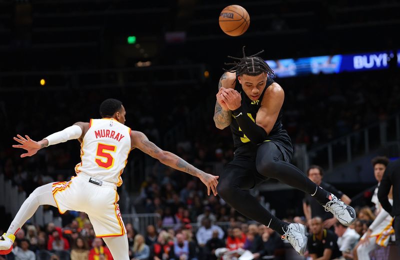 ATLANTA, GEORGIA - FEBRUARY 27:  Keyonte George #3 of the Utah Jazz ducks as he leaps after Dejounte Murray #5 of the Atlanta Hawks knocked a pass away during the third quarter at State Farm Arena on February 27, 2024 in Atlanta, Georgia.  NOTE TO USER: User expressly acknowledges and agrees that, by downloading and/or using this photograph, user is consenting to the terms and conditions of the Getty Images License Agreement.  (Photo by Kevin C. Cox/Getty Images)