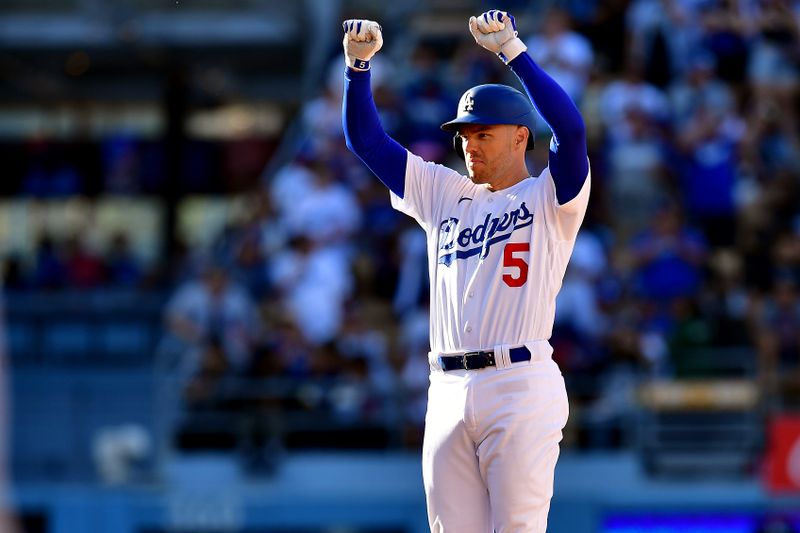 Jun 25, 2023; Los Angeles, California, USA; Los Angeles Dodgers first baseman Freddie Freeman (5) reacts after recording his 2,000th career hit on an RBI double against the Houston Astros during the eighth inning at Dodger Stadium. Mandatory Credit: Gary A. Vasquez-USA TODAY Sports