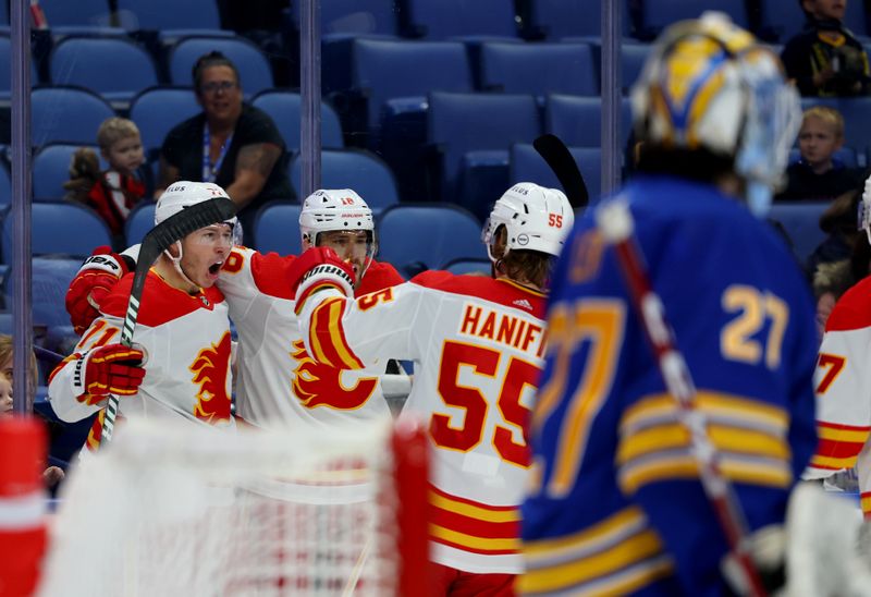 Oct 19, 2023; Buffalo, New York, USA;  Calgary Flames center Walker Duehr (71) celebrates his goal with teammates during the first period against the Buffalo Sabres at KeyBank Center. Mandatory Credit: Timothy T. Ludwig-USA TODAY Sports