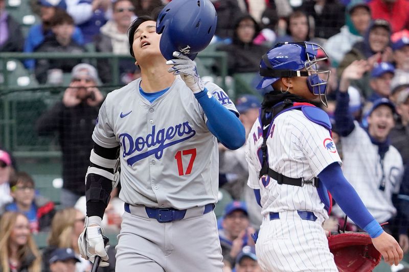 Apr 7, 2024; Chicago, Illinois, USA; Los Angeles Dodgers designated hitter Shohei Ohtani (17) strikes out against the Chicago Cubs during the first inning at Wrigley Field. Mandatory Credit: David Banks-USA TODAY Sports