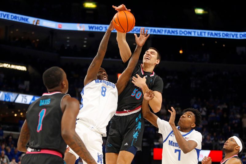 Feb 25, 2024; Memphis, Tennessee, USA; Memphis Tigers forward David Jones (8) and Florida Atlantic Owls center Vladislav Goldin (50) battle for a rebound during the second half at FedExForum. Mandatory Credit: Petre Thomas-USA TODAY Sports