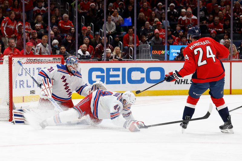 Dec 23, 2025; Washington, District of Columbia, USA; New York Rangers defenseman Vladislav Gavrikov (44) blocks a shot on Rangers goaltender Igor Shesterkin (31) by Washington Capitals center Connor McMichael (24) during the first period at Capital One Arena. Mandatory Credit: Geoff Burke-Imagn Images