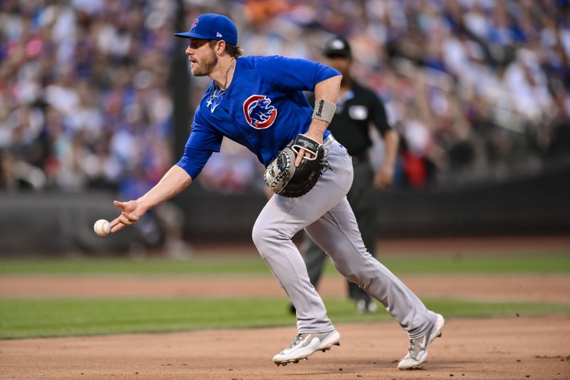 Aug 9, 2023; New York City, New York, USA; Chicago Cubs third baseman Patrick Wisdom (16) fields a ground ball and tosses it to first base for an out against the New York Mets during the second inning at Citi Field. Mandatory Credit: John Jones-USA TODAY Sports