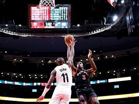 TORONTO, ON - DECEMBER 23: OG Anunoby #3 of the Toronto Raptors goes to the basket against Kris Dunn #11 of the Utah Jazz during the second half of their basketball game at the Scotiabank Arena on December 23, 2023 in Toronto, Ontario, Canada. NOTE TO USER: User expressly acknowledges and agrees that, by downloading and/or using this Photograph, user is consenting to the terms and conditions of the Getty Images License Agreement. (Photo by Mark Blinch/Getty Images)