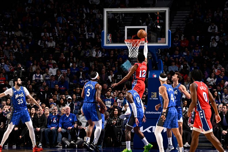 PHILADELPHIA, PA - APRIL 12: Tobias Harris #12 of the Philadelphia 76ers drives to the basket during the game against the Orlando Magic on April 12, 2024 at the Wells Fargo Center in Philadelphia, Pennsylvania NOTE TO USER: User expressly acknowledges and agrees that, by downloading and/or using this Photograph, user is consenting to the terms and conditions of the Getty Images License Agreement. Mandatory Copyright Notice: Copyright 2024 NBAE (Photo by David Dow/NBAE via Getty Images)