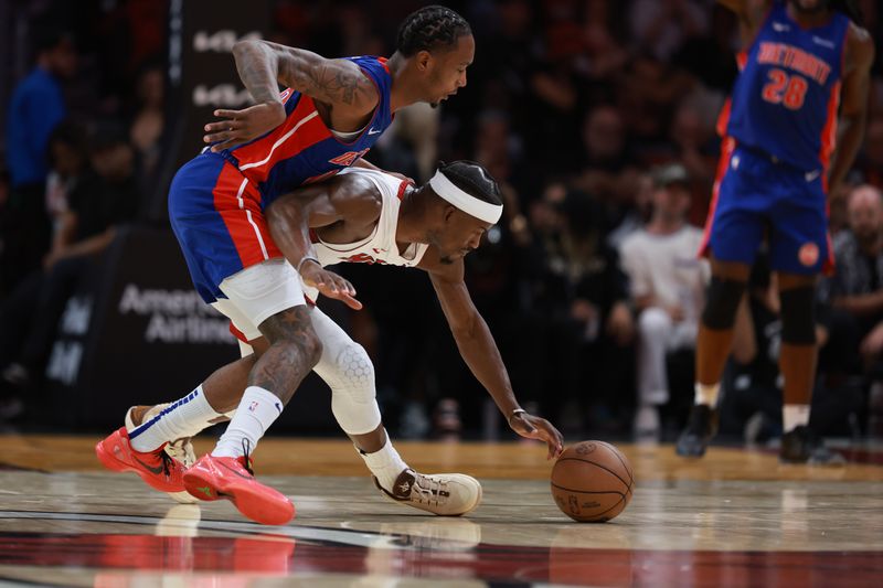 MIAMI, FLORIDA - OCTOBER 28: Jimmy Butler #22 of the Miami Heat reaches for a loose ball ahead of Ronald Holland II #00 of the Detroit Pistons during the first half at Kaseya Center on October 28, 2024 in Miami, Florida. NOTE TO USER: User expressly acknowledges and agrees that, by downloading and or using this photograph, User is consenting to the terms and conditions of the Getty Images License Agreement. (Photo by Carmen Mandato/Getty Images)