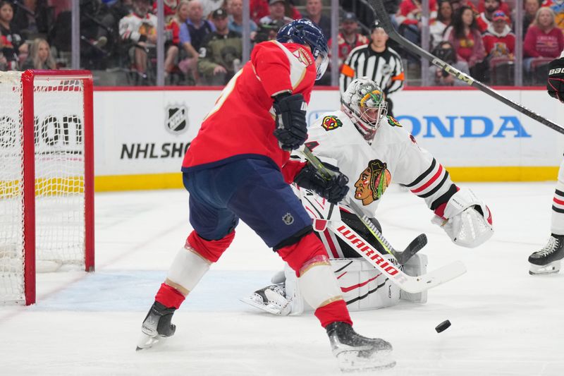 Feb 1, 2025; Sunrise, Florida, USA;  Florida Panthers defenseman Adam Boqvist (34) clears the puck as Florida Panthers center Sam Bennett (9) closes in during the second period at Amerant Bank Arena. Mandatory Credit: Jim Rassol-Imagn Images