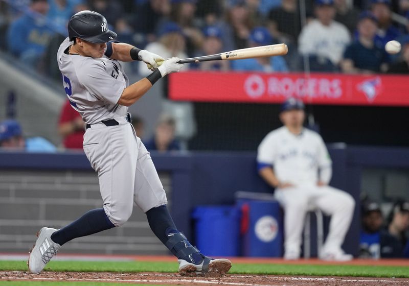 Apr 15, 2024; Toronto, Ontario, CAN; New York Yankees shortstop Anthony Volpe wearing number 42 for Jackie Robinson Day hits a single against the Toronto Blue Jays during the second inning at Rogers Centre. Mandatory Credit: Nick Turchiaro-USA TODAY Sports