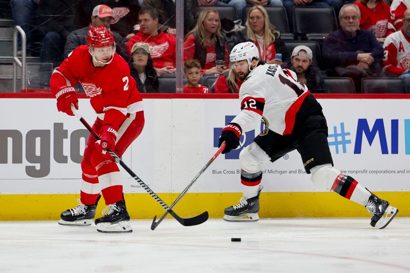 Jan 31, 2024; Detroit, Michigan, USA;  Detroit Red Wings defenseman Olli Maatta (2) skates with the puck chased by Ottawa Senators center Mark Kastelic (12) in the first period at Little Caesars Arena. Mandatory Credit: Rick Osentoski-USA TODAY Sports