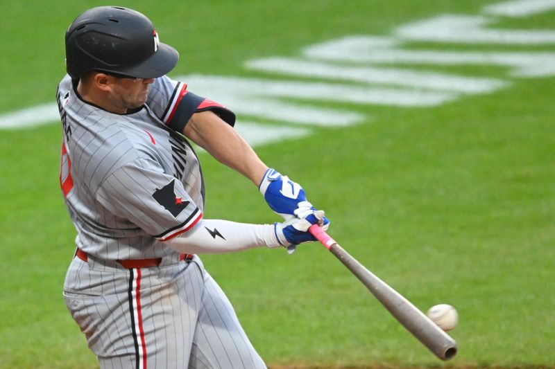 Apr 28, 2025; Cleveland, Ohio, USA; Minnesota Twins third baseman Jonah Bride (31) hits an RBI single in the fifth inning against the Cleveland Guardians at Progressive Field. Mandatory Credit: David Richard-Imagn Images
