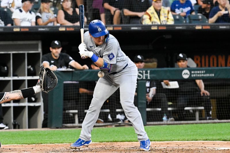 Jun 24, 2024; Chicago, Illinois, USA;  Los Angeles Dodgers catcher Will Smith (16) is hit by a pitch thrown by Chicago White Sox pitcher Garrett Crochet (45) during the third inning at Guaranteed Rate Field. Mandatory Credit: Matt Marton-USA TODAY Sports