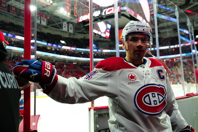 Dec 28, 2023; Raleigh, North Carolina, USA; Montreal Canadiens center Nick Suzuki (14) comes off the ice after the warmups against the Carolina Hurricanes at PNC Arena. Mandatory Credit: James Guillory-USA TODAY Sports