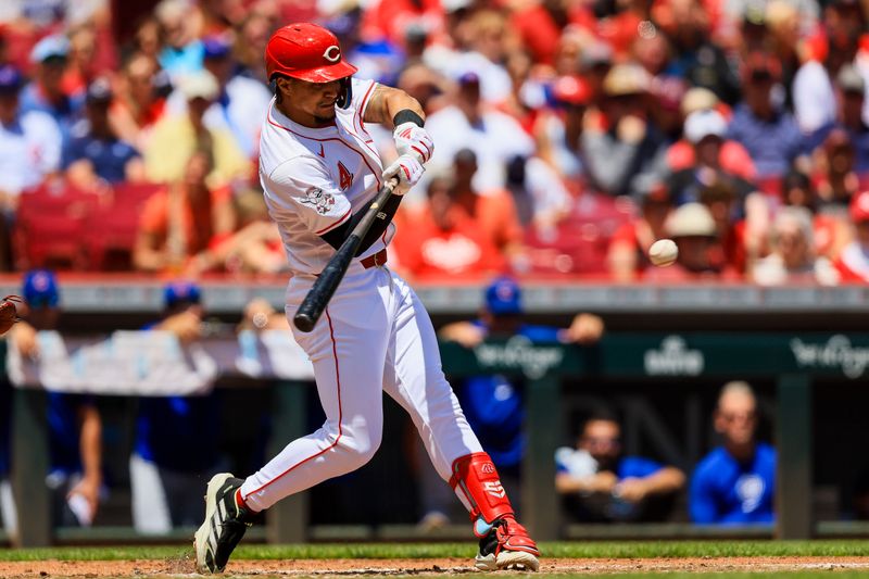 Jun 9, 2024; Cincinnati, Ohio, USA; Cincinnati Reds third baseman Santiago Espinal (4) hits a single against the Chicago Cubs in the second inning at Great American Ball Park. Mandatory Credit: Katie Stratman-USA TODAY Sports