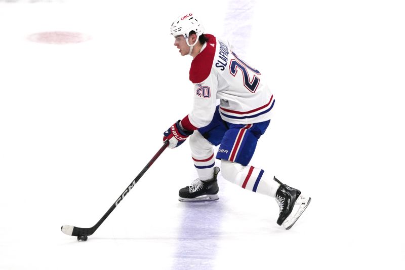 Dec 30, 2023; Sunrise, Florida, USA;  Montreal Canadiens left wing Juraj Slafkovsky (20) brings the puck up the ice against the Florida Panthers during the second period at Amerant Bank Arena. Mandatory Credit: Jim Rassol-USA TODAY Sports