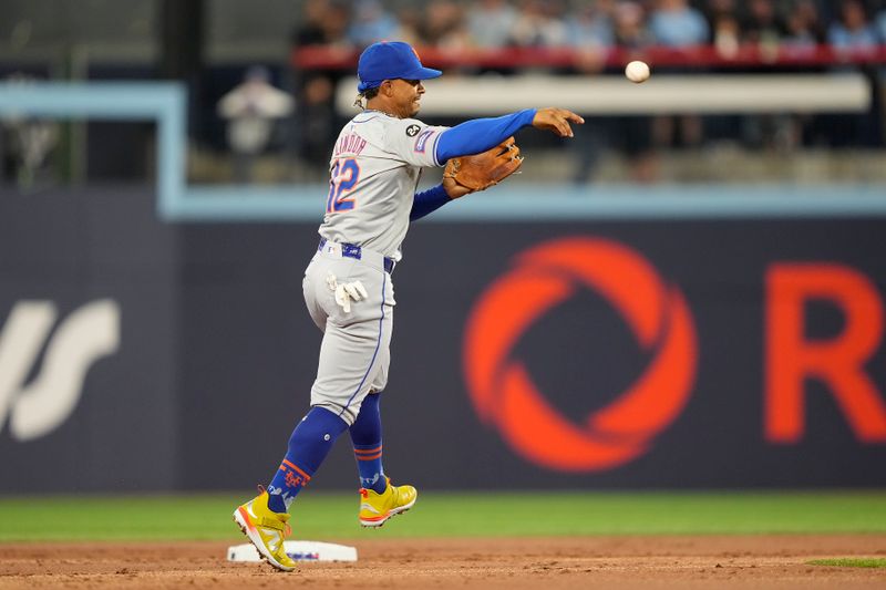 Sep 9, 2024; Toronto, Ontario, CAN; New York Mets shortstop Francisco Lindor (12) throws Toronto Blue Jays right fielder George Springer (not pictured) out at first base during the first inning at Rogers Centre. Mandatory Credit: John E. Sokolowski-Imagn Images