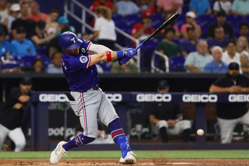 Jun 2, 2024; Miami, Florida, USA; Texas Rangers right fielder Robbie Grossman (4) hits an RBI single against the Miami Marlins during the first inning at loanDepot Park. Mandatory Credit: Sam Navarro-USA TODAY Sports
