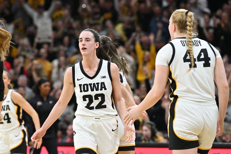 Mar 3, 2024; Iowa City, Iowa, USA; Iowa Hawkeyes guard Caitlin Clark (22) reacts with forward Addison O'Grady (44) after breaking the NCAA basketball all-time scoring record during the second quarter against the Ohio State Buckeyes. Mandatory Credit: Jeffrey Becker-USA TODAY Sports