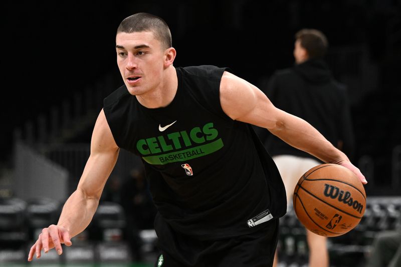 BOSTON, MASSACHUSETTS - DECEMBER 18: Payton Pritchard #11 of the Boston Celtics dribbles the ball during warmups before a game against the Orlando Magic at the TD Garden on December 18, 2022 in Boston, Massachusetts. NOTE TO USER: User expressly acknowledges and agrees that, by downloading and or using this photograph, User is consenting to the terms and conditions of the Getty Images License Agreement. (Photo by Brian Fluharty/Getty Images)