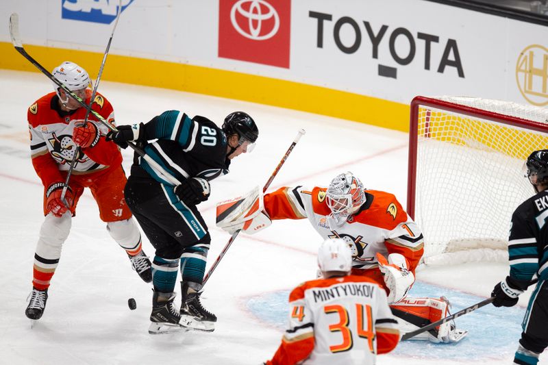 Oct 12, 2024; San Jose, California, USA; Anaheim Ducks defenseman Brian Dumoulin (6), San Jose Sharks left winger Fabian Zetterlund (20) and Anaheim goaltender Lukas Dostal (1) battle for the puck during the first period at SAP Center at San Jose. Mandatory Credit: D. Ross Cameron-Imagn Images