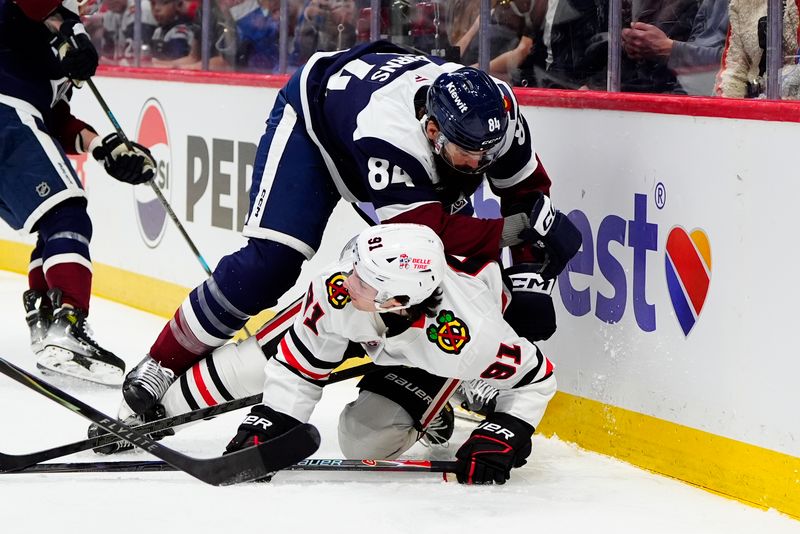 Feb 28, 2026; Denver, Colorado, USA; Colorado Avalanche defenseman Brent Burns (84) hits Chicago Blackhawks center Frank Nazar (91) in the first period at Ball Arena. Mandatory Credit: Ron Chenoy-Imagn Images