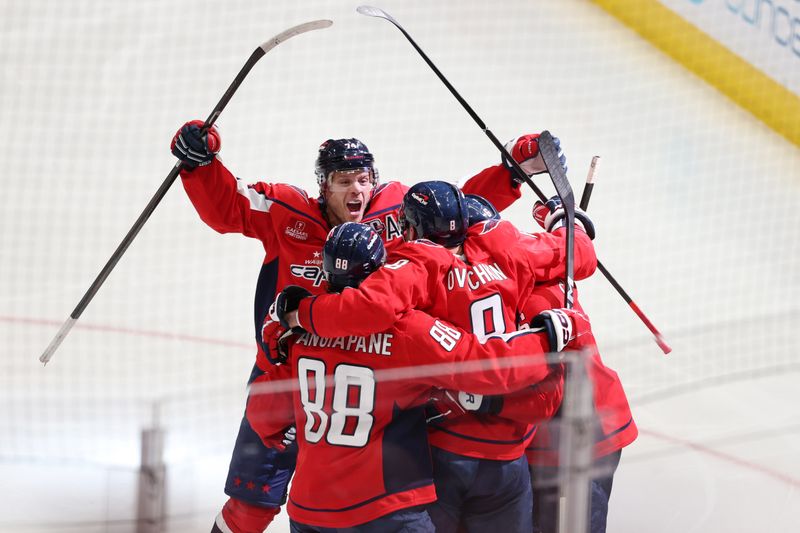 Apr 4, 2025; Washington, District of Columbia, USA; Washington Capitals left wing Alex Ovechkin (8) celebrates with teammates after scoring a goal against the Chicago Blackhawks in the third period at Capital One Arena. The goal is the 894th of his career, tying Wayne Gretzky (not pictured) for most all-time goals scored in the NHL. Mandatory Credit: Amber Searls-Imagn Images