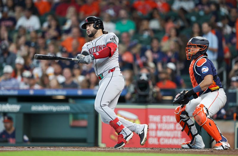 Sep 8, 2024; Houston, Texas, USA; Arizona Diamondbacks third baseman Eugenio Suarez (28) hits a single during the second inning against the Houston Astros at Minute Maid Park. Mandatory Credit: Troy Taormina-Imagn Images
