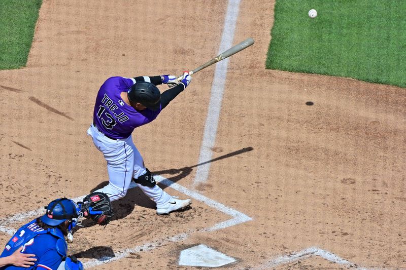 Mar 6, 2023; Salt River Pima-Maricopa, Arizona, USA; Colorado Rockies shortstop Alan Trejo (13) doubles in the third inning against the Texas Rangers during a Spring Training game at Salt River Fields at Talking Stick. Mandatory Credit: Matt Kartozian-USA TODAY Sports