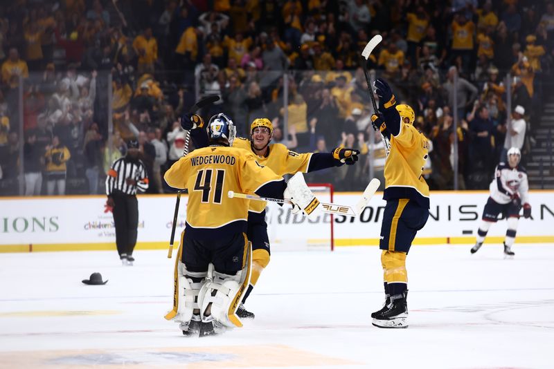 Oct 26, 2024; Nashville, Tennessee, USA; Nashville Predators teammates celebrate with goaltender Scott Wedgewood (41) after a win in overtime against the Columbus Blue Jackets at Bridgestone Arena. Mandatory Credit: Casey Gower-Imagn Images
