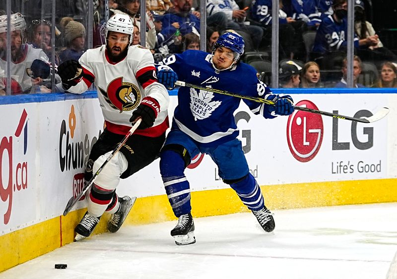 Sep 24, 2022; Toronto, Ontario, CAN; Ottawa Senators forward Mark Kastelic (47) tries to avoid a check from Toronto Maple Leafs forward Nicholas Robertson (89) during the first period at Scotiabank Arena. Mandatory Credit: John E. Sokolowski-USA TODAY Sports