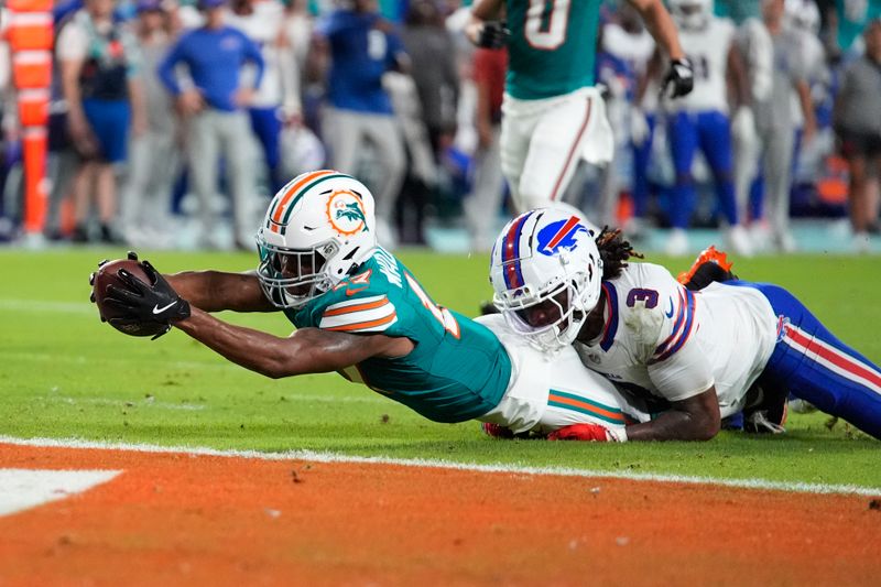 Buffalo Bills safety Damar Hamlin (3) grabs Miami Dolphins wide receiver Jaylen Waddle (17) short of the end zone during the first half of an NFL football game, Thursday, Sept. 12, 2024, in Miami Gardens, Fla. (AP Photo/Rebecca Blackwell)