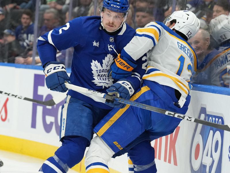 Mar 6, 2024; Toronto, Ontario, CAN; Toronto Maple Leafs defenseman Simon Benoit (2) battles along the boards with Buffalo Sabres left wing Jordan Greenway (12) during the third period at Scotiabank Arena. Mandatory Credit: Nick Turchiaro-USA TODAY Sports