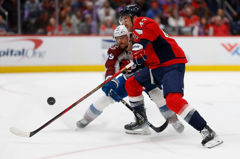 Nov 21, 2024; Washington, District of Columbia, USA; Colorado Avalanche defenseman Samuel Girard (49) and Washington Capitals right wing Tom Wilson (43) battle for the puck in the third period at Capital One Arena. Mandatory Credit: Geoff Burke-Imagn Images