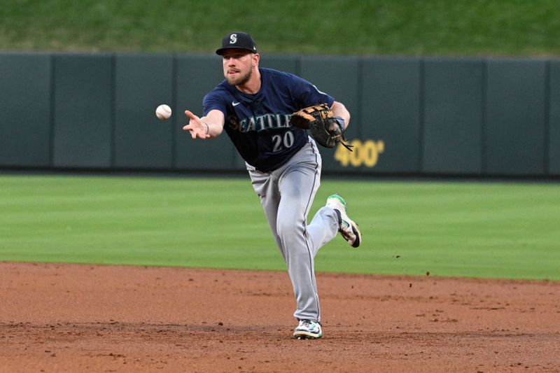 Sep 7, 2024; St. Louis, Missouri, USA; Seattle Mariners first baseman Luke Raley (20) tosses to first base for an out against the St. Louis Cardinals in the third inning at Busch Stadium. Mandatory Credit: Joe Puetz-Imagn Images