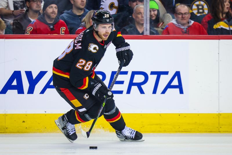 Feb 28, 2023; Calgary, Alberta, CAN; Calgary Flames center Elias Lindholm (28) controls the puck against the Boston Bruins during the third period at Scotiabank Saddledome. Mandatory Credit: Sergei Belski-USA TODAY Sports