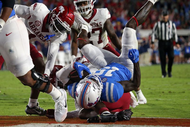 Oct 7, 2023; Oxford, Mississippi, USA; Mississippi Rebels wide receiver Dayton Wade (19) rolls over an Arkansas Razorbacks defender for a touchdown during the first half at Vaught-Hemingway Stadium. Mandatory Credit: Petre Thomas-USA TODAY Sports