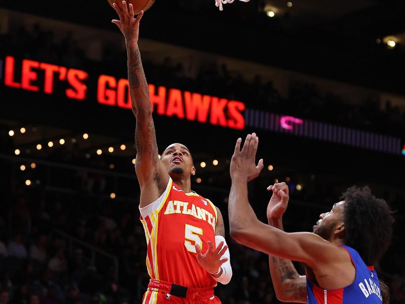 ATLANTA, GEORGIA - DECEMBER 18:  Dejounte Murray #5 of the Atlanta Hawks lays in a basket against Marvin Bagley III #35 of the Detroit Pistons during the second quarter at State Farm Arena on December 18, 2023 in Atlanta, Georgia.  NOTE TO USER: User expressly acknowledges and agrees that, by downloading and/or using this photograph, user is consenting to the terms and conditions of the Getty Images License Agreement.  (Photo by Kevin C. Cox/Getty Images)