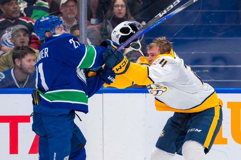 Jan 3, 2025; Vancouver, British Columbia, CAN; Vancouver Canucks forward Nils Hoglander (21) battles with Nashville Predators defenseman Spencer Stastney (24) in the second period at Rogers Arena. Mandatory Credit: Bob Frid-Imagn Images