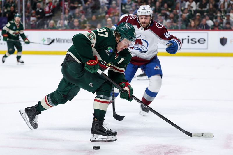 Nov 28, 2025; Saint Paul, Minnesota, USA; Minnesota Wild left wing Kirill Kaprizov (97) skates with the puck alongside Colorado Avalanche defenseman Samuel Girard (49) during the second period at Grand Casino Arena. Mandatory Credit: Matt Krohn-Imagn Images
