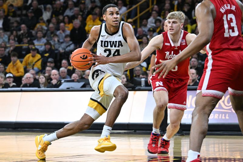 Mar 5, 2023; Iowa City, Iowa, USA; Iowa Hawkeyes forward Kris Murray (24) goes to the basket as Nebraska Cornhuskers forward Derrick Walker (13) and guard Sam Griesel (5) defend during the second half at Carver-Hawkeye Arena. Mandatory Credit: Jeffrey Becker-USA TODAY Sports