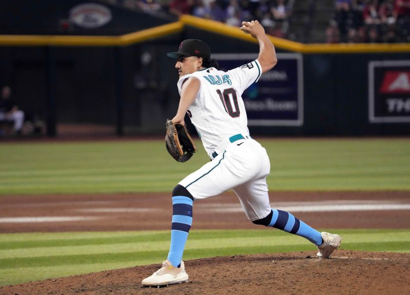 Jun 18, 2023; Phoenix, Arizona, USA; Arizona Diamondbacks relief pitcher Josh Rojas (10) throws against the Cleveland Guardians during the ninth inning at Chase Field. Mandatory Credit: Joe Camporeale-USA TODAY Sports