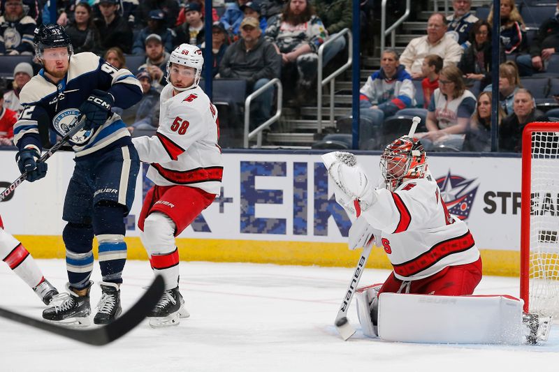 Feb 29, 2024; Columbus, Ohio, USA; Carolina Hurricanes goalie Spencer Martin (41) makes a save on the tip attempt from Columbus Blue Jackets left wing Alexander Nylander (92) during the first period at Nationwide Arena. Mandatory Credit: Russell LaBounty-USA TODAY Sports