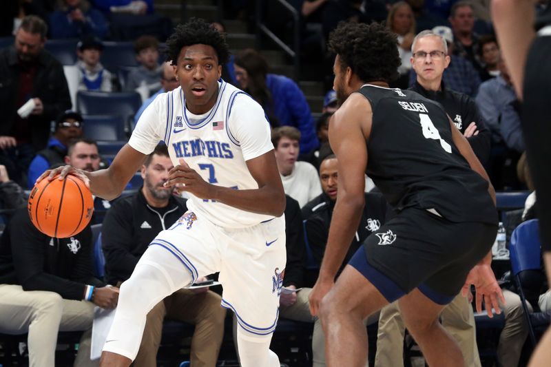 Jan 31, 2024; Memphis, Tennessee, USA; Memphis Tigers forward Nae'Qwan Tomlin (7) drives to the basket as Rice Owls guard Anthony Selden (4) defends during the first half at FedExForum. Mandatory Credit: Petre Thomas-USA TODAY Sports