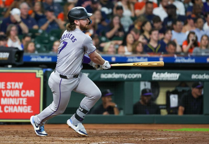 Jun 25, 2024; Houston, Texas, USA;  Colorado Rockies second baseman Brendan Rodgers (7) hits a single against the Houston Astros in the fourth inning at Minute Maid Park. Mandatory Credit: Thomas Shea-USA TODAY Sports