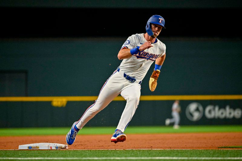 Apr 10, 2024; Arlington, Texas, USA; Texas Rangers left fielder Evan Carter (32) scores against the Oakland Athletics during the first inning at Globe Life Field. Mandatory Credit: Jerome Miron-USA TODAY Sports