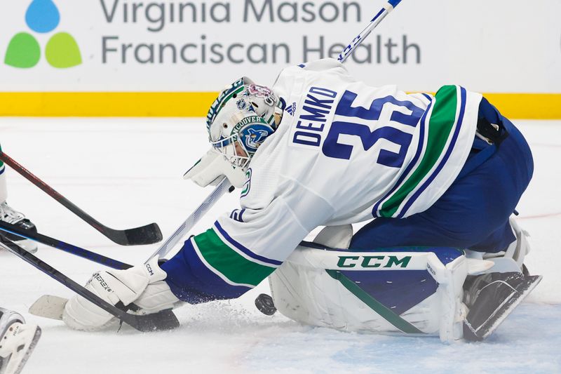 Oct 1, 2022; Seattle, Washington, USA; Vancouver Canucks goaltender Thatcher Demko (35) fails to save the puck against the Seattle Kraken during the third period at Climate Pledge Arena. The puck would slip wide of the net. Mandatory Credit: Joe Nicholson-USA TODAY Sports