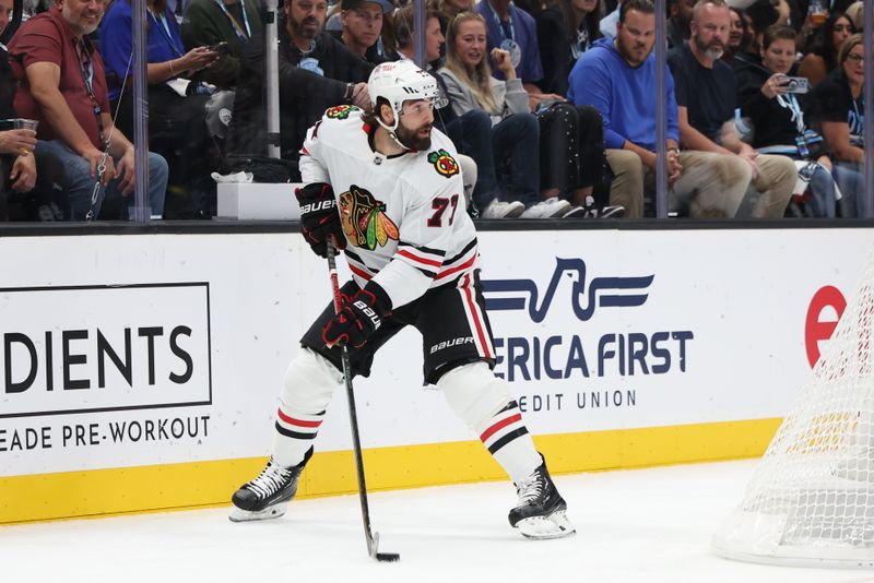 Oct 8, 2024; Salt Lake City, Utah, USA; Chicago Blackhawks left wing Patrick Maroon (77) looks to pass the puck against the Utah Hockey Club during the first period at Delta Center. Mandatory Credit: Rob Gray-Imagn Images