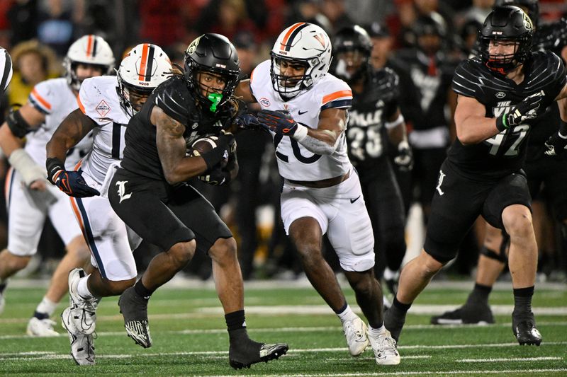 Nov 9, 2023; Louisville, Kentucky, USA; Louisville Cardinals wide receiver Kevin Coleman (3) runs the ball against Virginia Cavaliers safety Jonas Sanker (20) during the second half at L&N Federal Credit Union Stadium. Louisville defeated Virginia 31-24. Mandatory Credit: Jamie Rhodes-USA TODAY Sports