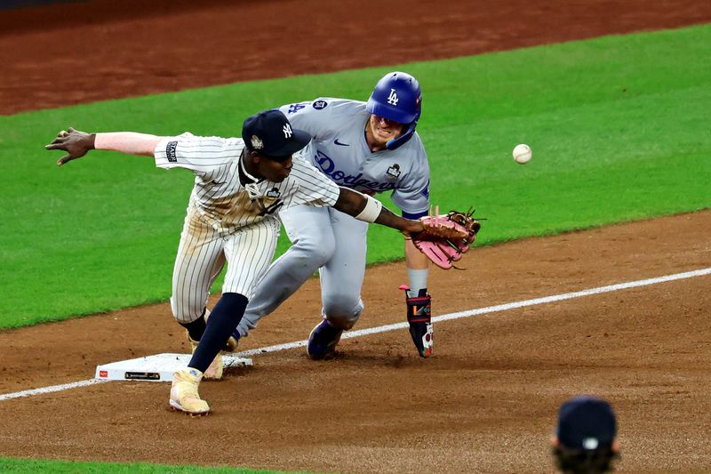 Oct 30, 2024; Bronx, New York, USA; Los Angeles Dodgers third baseman Enrique Hernandez (8) reaches third base after an error by New York Yankees third baseman Jazz Chisholm Jr. (13) during the fifth inning during game five of the 2024 MLB World Series at Yankee Stadium. Mandatory Credit: James Lang-Imagn Images