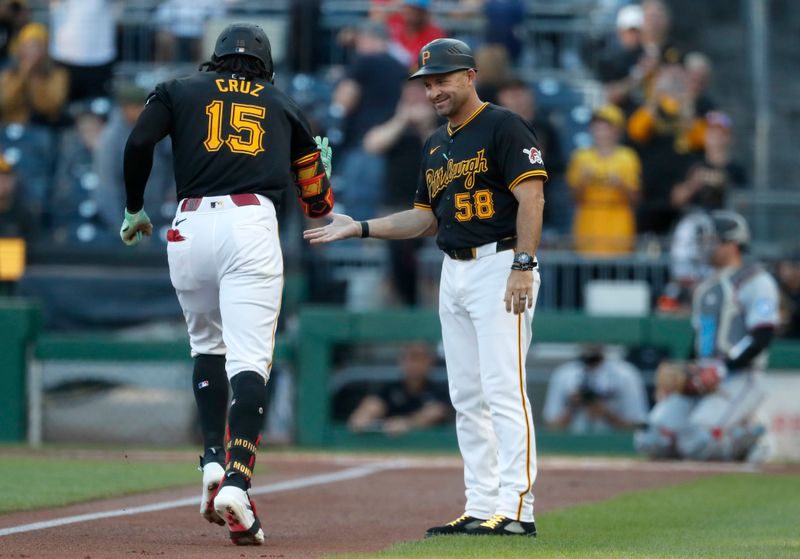 Sep 9, 2024; Pittsburgh, Pennsylvania, USA;  Pittsburgh Pirates third base coach Mike Rabelo (58) congratulates center fielder Oneil Cruz (15) after a solo home run against the Miami Marlins during the first inning at PNC Park. Mandatory Credit: Charles LeClaire-Imagn Images